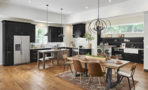 Wide kitchen and dining area with black cabinets.