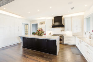 Wide view of white cabinets in kitchen area.